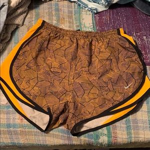 Orange and black nike running shorts